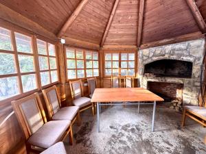 a dining room with a table and a fireplace at Apartmani Megara Vlasic in Šišava