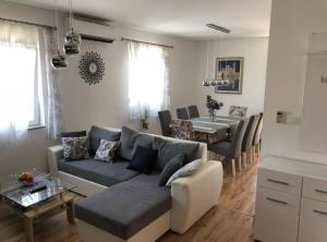 a living room with a couch and a dining room at Holiday House Franov in Zadar