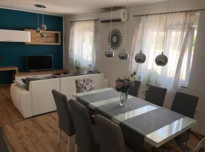 a living room with a table and a couch at Holiday House Franov in Zadar