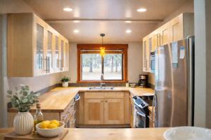 a kitchen with a stainless steel refrigerator and a window at Lodge Condo 031 in Black Butte Ranch