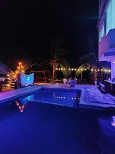 ein Schwimmbad bei Nacht mit Lichtern in der Unterkunft Fiesta Zipolite in Zipolite + 27 Fotos