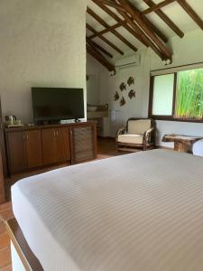 a bedroom with a bed and a flat screen tv at Rancho Eden in Armenia
