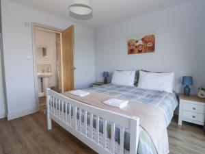 a white bed with two towels on it in a bedroom at Genesis in Richmond