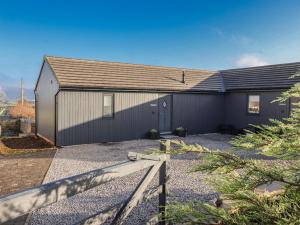 a house with a gray garage with a roof at Genesis in Richmond