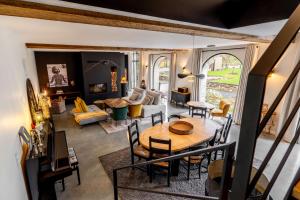 an aerial view of a living room with a table at Les Granges de Juvardeil in Juvardeil