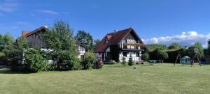 a large house with a yard with a playground at Dabki Village - Villa Rena in Dąbki
