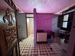 a room with a purple wall and a room with a floor at Hacienda Cordova in San Sebastián Etla