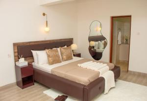 a bedroom with a large bed and a mirror at Rupa villas in Eldoret