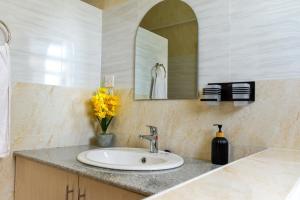 a bathroom with a sink and a mirror at Rupa villas in Eldoret