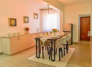 a kitchen with a table with chairs and a refrigerator at Rupa villas in Eldoret +26 photos