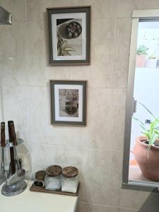 a bathroom with two framed pictures on the wall at Casa de la abuelita in Cazorla +31 photos