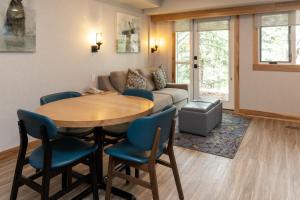 a living room with a table and a couch at Tunnel Mountain Resort in Banff