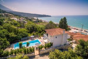 a villa with a swimming pool and a beach at Villa Lourdas Beach by Villa Plus in Trápeza