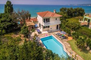 an aerial view of a house with a swimming pool at Villa Lourdas Beach by Villa Plus in Trápeza