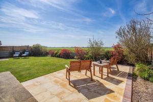 a patio with two wooden benches and a table at 3 Bed in Walcott oc-2135 in Walcott
