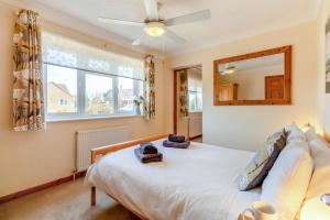 a bedroom with a bed with a ceiling fan and a mirror at 3 Bed in Walcott oc-2135 in Walcott