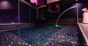 a bathroom with a tub with a water fountain at V Boutique Periférico Sur in Mexico City +12 photos