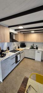 a large kitchen with white appliances and wooden cabinets at A3 Valencia Ciudad cómodo Bajo Diseño hasta 6, wifi gratis in Valencia