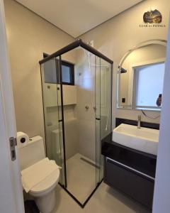 a bathroom with a shower and a toilet and a sink at Casa Luar de Pitinga in Arraial d'Ajuda +10 photos