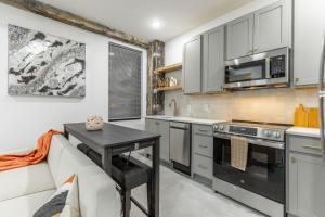 a kitchen with a couch and a table and a microwave at Park Hotel 1BR Suite 410 in Chattanooga