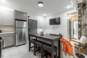 a kitchen with a table and chairs and a refrigerator at Park Hotel 1BR Suite 410 in Chattanooga