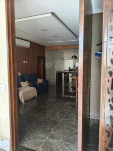 a living room with a couch and a table at Paraíso do aconchego in Aparecida de Goiânia
