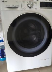 a white washing machine with a black door at Paraíso do aconchego in Aparecida de Goiânia