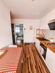 a kitchen with a table with a checkered table cloth at Apartament 5 minut od Parku Zamkowego in Pszczyna +22 photos