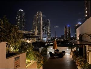 a view of a city at night from a rooftop at VAUX Park Street Hotel - A collection of 8 luxury lofts in Colombo