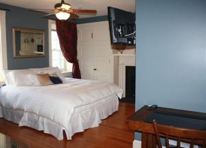 a bedroom with a white bed and a pool table at Stocks Manor Bed and Breakfast in Mechanicsburg