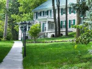 a large stone house with a pathway in front of it at Stocks Manor Bed and Breakfast in Mechanicsburg