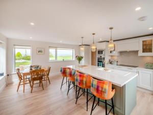 a kitchen with a island and a table with chairs at 3 Bed in Cashel oc-a32863 in Glinsk