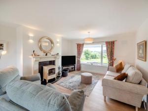 a living room with two couches and a fireplace at 3 Bed in Cashel oc-a32863 in Glinsk