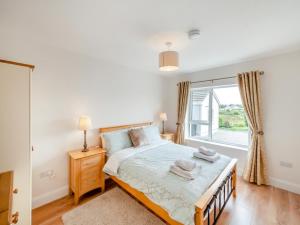 a bedroom with a bed and a large window at 3 Bed in Cashel oc-a32863 in Glinsk