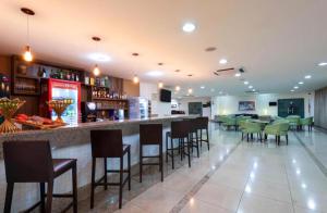 a bar in a restaurant with chairs and tables at Flat hotel Blue tree no adrianopolis Até 4 pessoas in Manaus