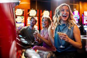 a group of people sitting in a bar holding wine glasses at Golden Nugget Laughlin in Laughlin
