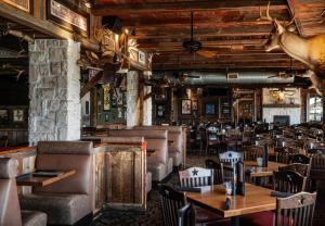 a restaurant with tables and chairs and a deer head on the wall at Golden Nugget Laughlin in Laughlin