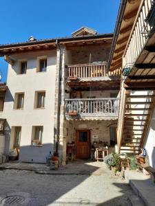 a large building with a staircase in front of it at Casa 1885 in Belluno