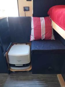 a small room with a bed and a suitcase at Kampervan in Vrhovine