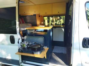 a kitchen in the back of an rv at Kampervan in Vrhovine +5 photos