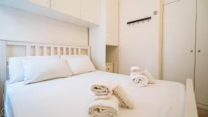 a bedroom with a white bed with towels on it at XX Settembre 68 in Alassio