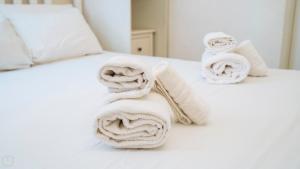 a pile of towels sitting on top of a bed at XX Settembre 68 in Alassio +46 photos