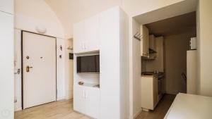 a kitchen with white cabinets and a refrigerator at XX Settembre 68 in Alassio