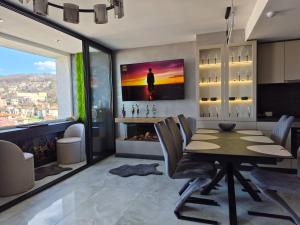 a dining room with a table and a fireplace at The View -Balkan Tower безплатно паркомясто in Gabrovo