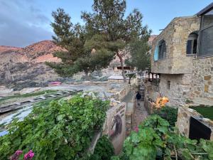 a stone house with a view of a river at TOWER Hotel in Dana