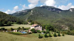 an aerial view of a house in the mountains at Allotjatments Can Servosa in Sales del Llierca