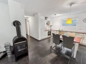 a kitchen with a fireplace and a table and chairs at Ferienwohnung W18 0 N in Graal-Müritz