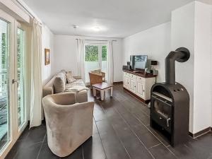 a living room with a wood stove and a couch at Ferienwohnung W18 0 N in Graal-Müritz