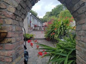 a brick alley way with flowers and plants at Ashleigh House Bed & Breakfast in Monaghan