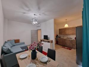 a living room with a table and a couch at Appartamento Denis in Rapallo